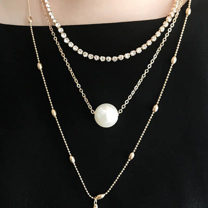 Silver Three-Layer Pearl Layered Necklace with Crystal Pendant and Geometric Chain Style